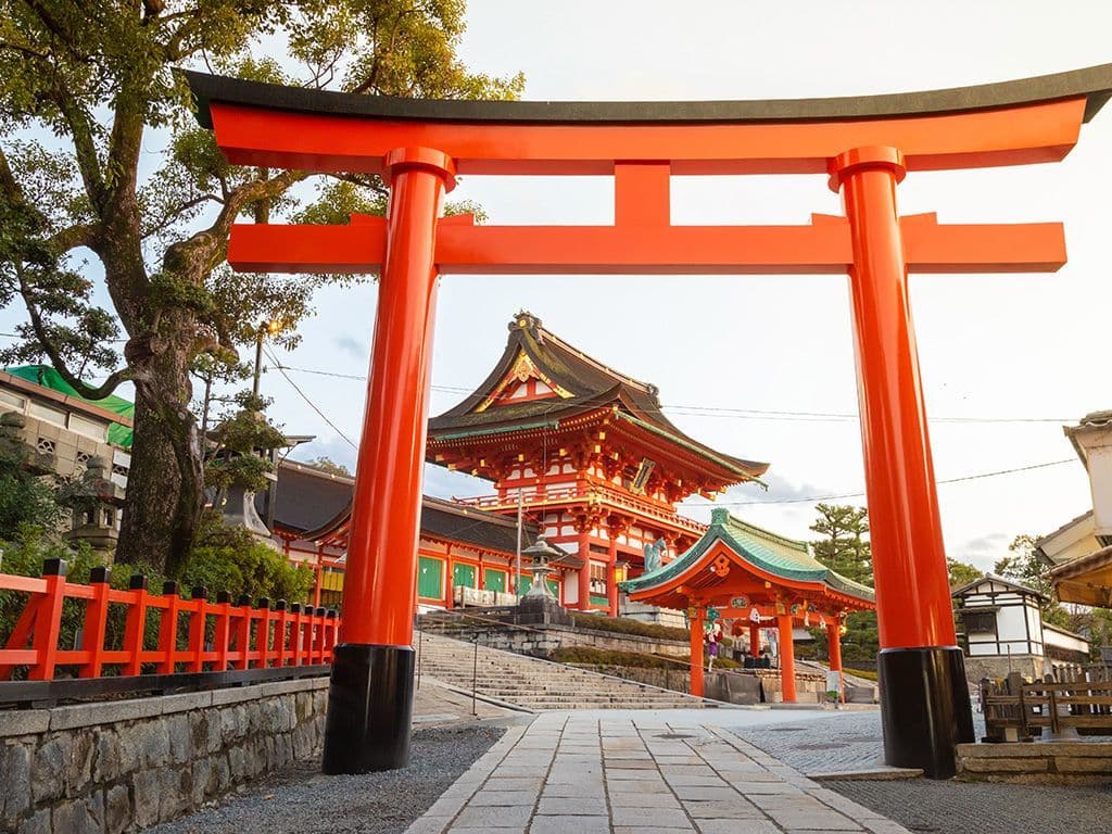 De galerij van scharlakenrode 'torii' of poorten die u ziet vormt het beroemdste
onderdeel van een shintoïstisch heiligdom in de Japanse stad Kioto. De tweedelige naam
van het heiligdom verwijst enerzijds naar de stadswijk waar het gelegen is en anderzijds
naar de godheid aan dewelke de schrijn is gewijd. Naam van die Japanse cultuurstek.